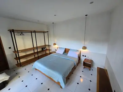 a bedroom with a bed and a tiled floor at Villa crush of heart with swimming pool in Umalas