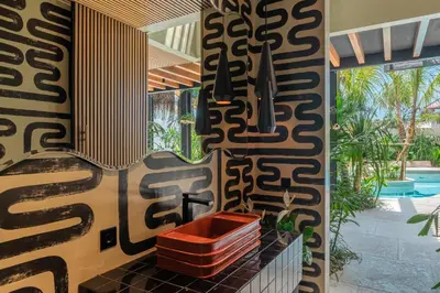 a bathroom with a red sink and a pool at Villa Baratega - Dreamy Urban Tropical 6BR Villa for Large Group in Kerobokan