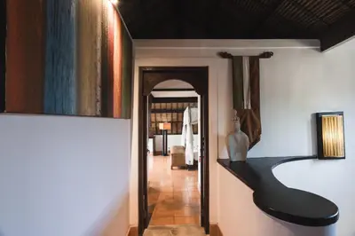 a hallway with a black bench in a room at Timang Villa, Jimbaran-Bali in Jimbaran
