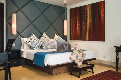 a bedroom with a large bed with pillows on it at Timang Villa, Jimbaran-Bali in Jimbaran