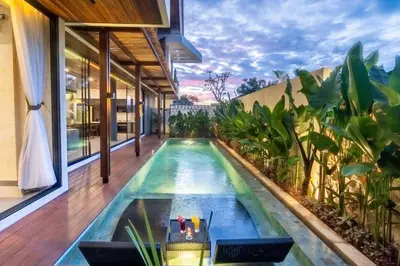 an infinity pool in the middle of a house at Oza Villa Canggu Managed by LEAD in Canggu
