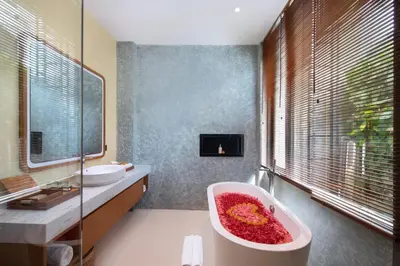 a bathroom with a red bath tub and a tv at Oza Villa Canggu Managed by LEAD in Canggu