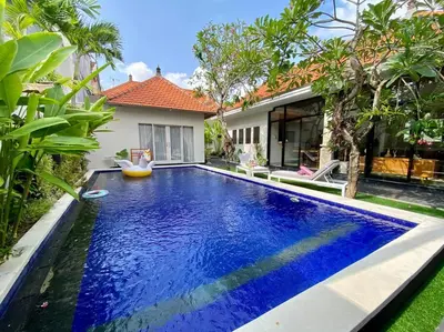 a swimming pool in the backyard of a house at Tranquil Family Villa Retreat in Umalas in Kerobokan