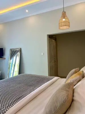 a bedroom with a bed with pillows on it at Tranquil Family Villa Retreat in Umalas in Kerobokan