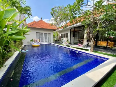 a swimming pool in the backyard of a house at Tranquil Family Villa Retreat in Umalas in Kerobokan
