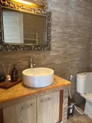 a bathroom with a sink and a mirror at Tranquil Family Villa Retreat in Umalas in Kerobokan