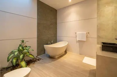 a bathroom with a white tub and a sink at Cozy villa in Umalas in Kerobokan
