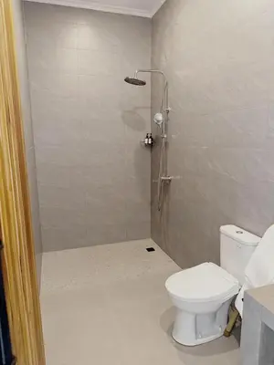 a bathroom with a shower and a toilet at Private Pool Seminyak Central 2BR Villa in Seminyak