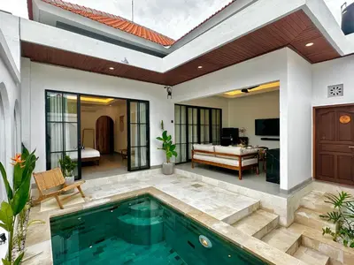 a villa with a swimming pool and a bedroom at Private Pool Seminyak Central 2BR Villa in Seminyak