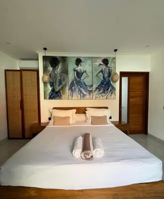 a bedroom with a large white bed with two towels at New 2BR Villa Private Pool Near Seminyak in Kerobokan
