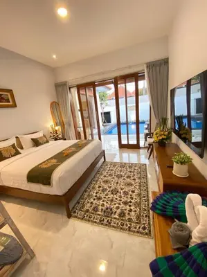 a bedroom with a large bed and a balcony at Arts Tamansari Villa Two-Bedroom Private Pool Kuta in Kerobokan