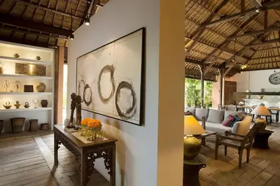 a living room with a table and a couch at Villa Mamoune in Canggu