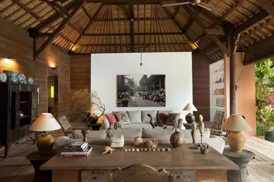 a living room with a couch and a table with lamps at Villa Mamoune in Canggu