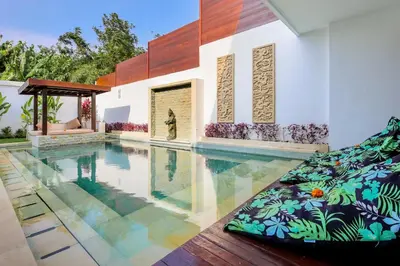 a swimming pool in a house at Villa Lilja in Seminyak