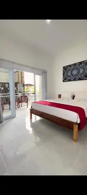 a bedroom with a bed and a large window at narayuka house in Seminyak