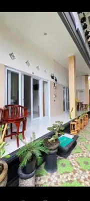 a large living room with potted plants and a table at narayuka house in Seminyak