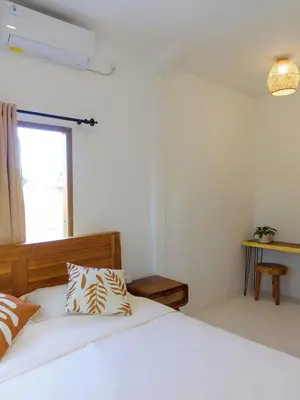 a bedroom with a bed and a window at Vee Surf in Canggu