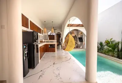 a kitchen and swimming pool in a house at Sueño Villa Seminyak in Seminyak