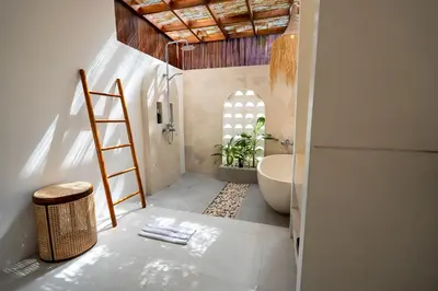 a bathroom with a ladder and a bath tub at Sueño Villa Seminyak in Seminyak