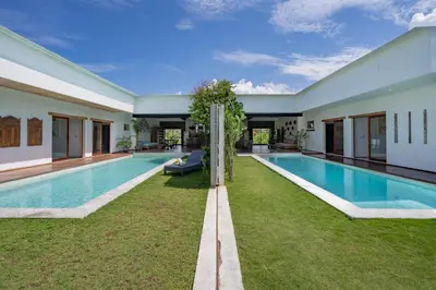 a swimming pool in the backyard of a house at Villa Jannu by DreamAwayBali in Seminyak