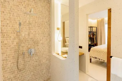 a bathroom with a walk in shower next to a bedroom at Balimac Villa 3 in Seminyak