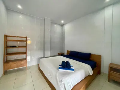 a bedroom with a bed with a pair of shoes on it at Family Villa with Private Pool in Central Seminyak in Seminyak