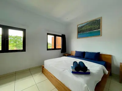 a bedroom with a bed with a blue tray on it at Family Villa with Private Pool in Central Seminyak in Seminyak