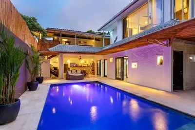 a swimming pool in the backyard of a house at Villa Julietta, 4 BR in the heart of Seminyak in Seminyak