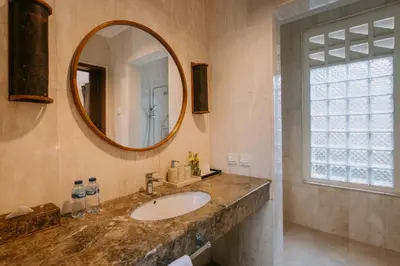 a bathroom with a sink and a mirror at Villa Anggrek Jimbaran in Jimbaran