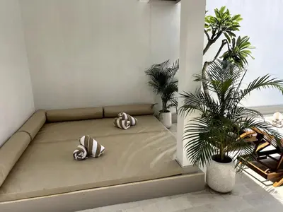 a bed in a room with two pillows on it at LUX 3 Bedroom Villa 5min Walk to the Beach in Canggu