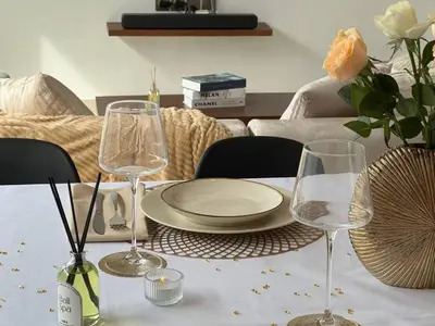 a table with a plate and two wine glasses at LUX 3 Bedroom Villa 5min Walk to the Beach in Canggu
