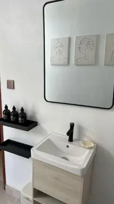 a bathroom with a white sink and a mirror at LUX 3 Bedroom Villa 5min Walk to the Beach in Canggu