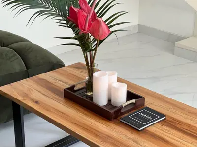 a table with a vase with red roses and candles at LUX Villa, Private Pool Berawa in Canggu