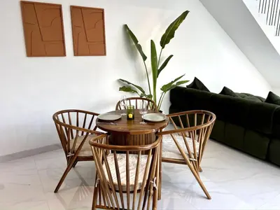 a wooden table and chairs in a living room at LUX Villa, Private Pool Berawa in Canggu