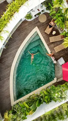 a man swimming in a pool in the water at Villa Soluna Luxury 4BD Villa with Pool & Zen Vibes in Seminyak
