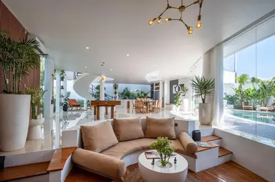 a living room with a couch and a pool at Villa Soluna Luxury 4BD Villa with Pool & Zen Vibes in Seminyak