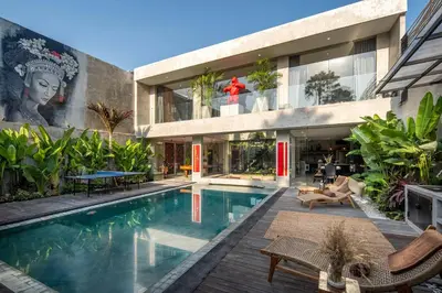 a house with a swimming pool in front of a building at Artistic 4BD Villa with Private Pool & Jungle Vibes in Seminyak