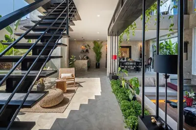 a staircase in a house with plants at Artistic 4BD Villa with Private Pool & Jungle Vibes in Seminyak