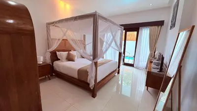 a bedroom with a canopy bed in a room at Private Villa Fabian - Lap pool - Seminyak in Seminyak