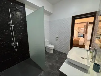 a bathroom with a shower and a toilet and a sink at Private Villa Fabian - Lap pool - Seminyak in Seminyak