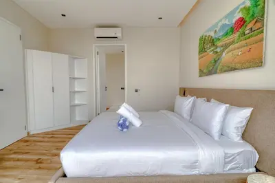 a bedroom with a large white bed with white pillows at Nirvana Villa 3BR Brand New in Umalas, Canggu in Kerobokan