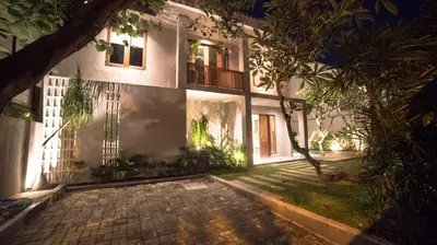 an exterior view of a house at night at Villa Gabrielle in Seminyak