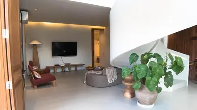 a living room with a tv and a potted plant at Villa Gabrielle in Seminyak
