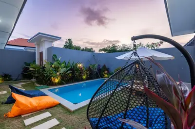 a backyard with a swimming pool and a fence at Ageta Villa 3 bedrooms Umalas with pool in Kerobokan