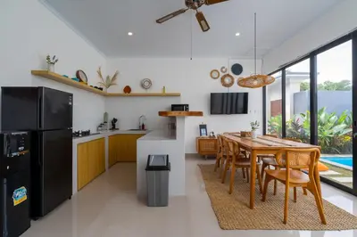 a kitchen and dining room with a table and chairs at Ageta Villa 3 bedrooms Umalas with pool in Kerobokan