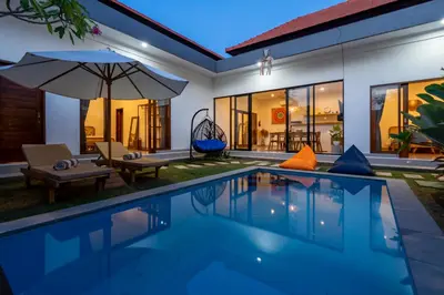a villa with a swimming pool at night at Ageta Villa 3 bedrooms Umalas with pool in Kerobokan