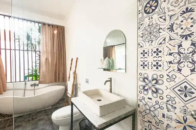 a bathroom with a tub and a sink and a bath tub at Cendani Private Pool Villa Bali in Kuta