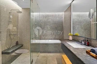 a bathroom with a shower and a sink at Moriya by Kozystay - Nusa Dua in Nusa Dua