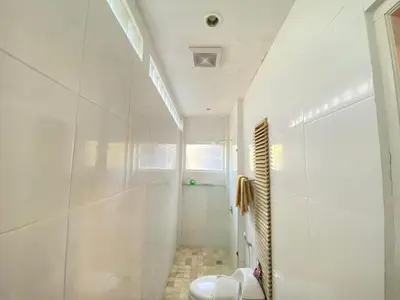a white bathroom with a shower and a toilet at 2bedroom Apartment Petitenget Beach in Seminyak