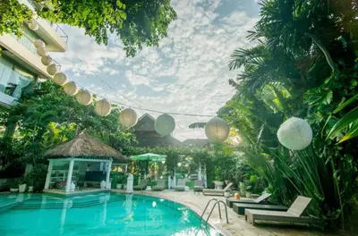 a swimming pool in a resort with palm trees at 2bedroom Apartment Petitenget Beach in Seminyak